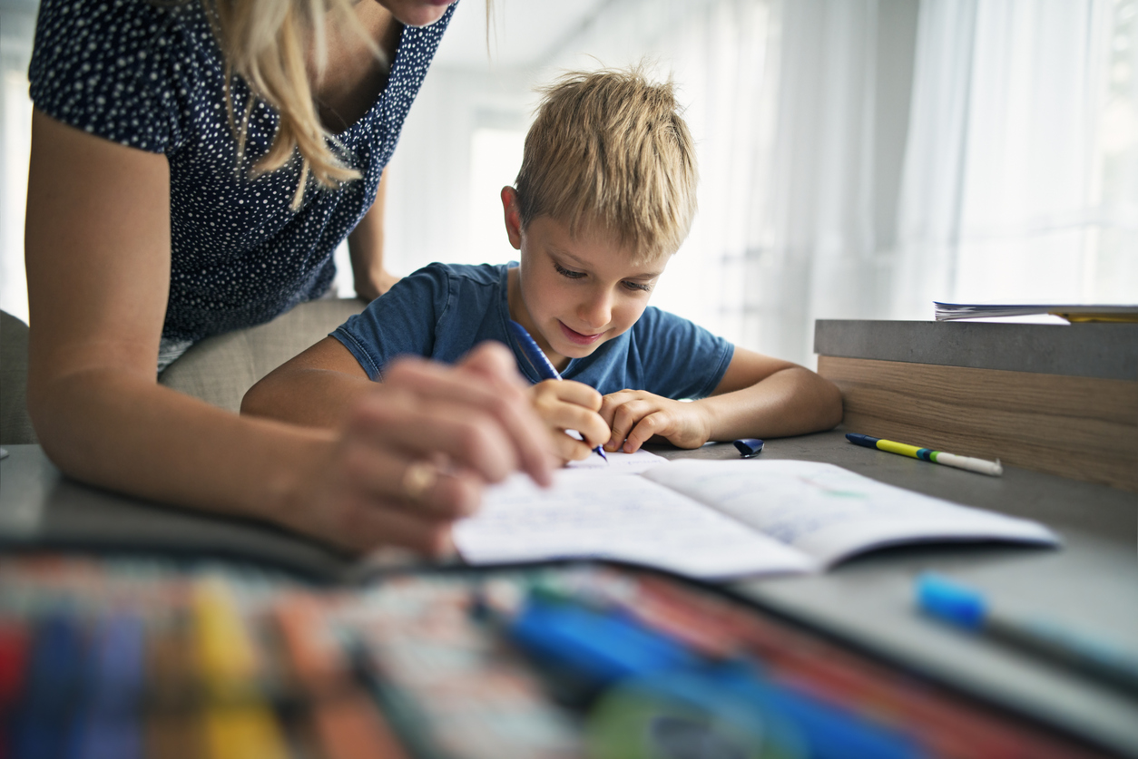 Mother helping son to do his homework